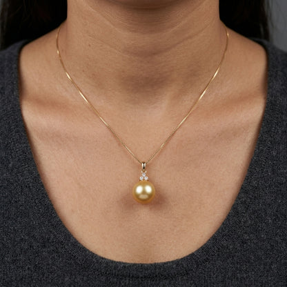 South Sea Golden Pearl and diamond pendant in 18K yellow gold featuring a 10 x 13 mm golden pearl and round diamond accents