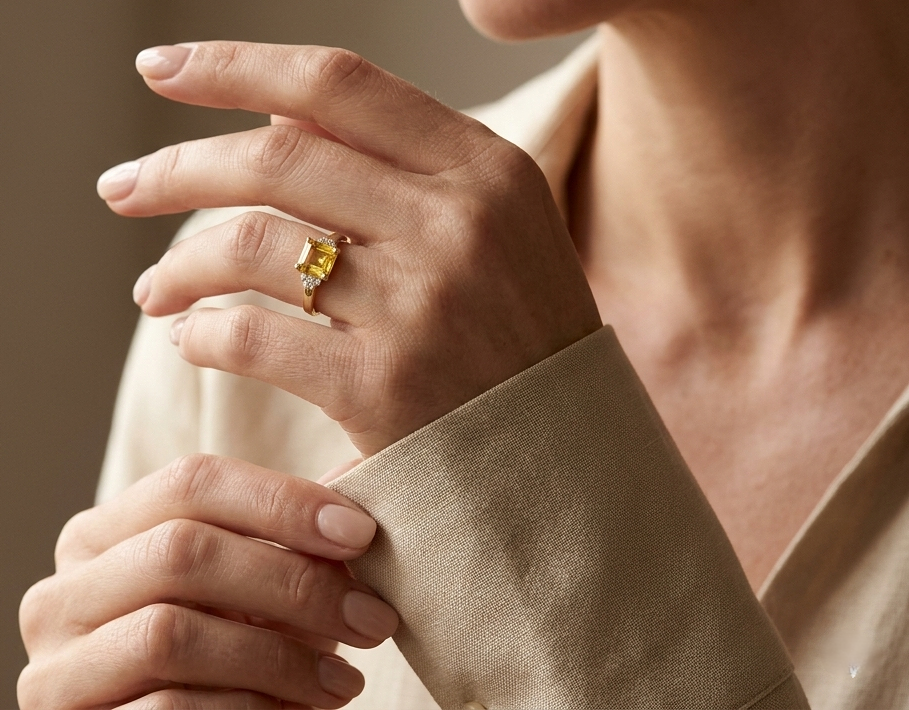 Emerald cut yellow sapphire ring in 18K yellow gold with diamond accents