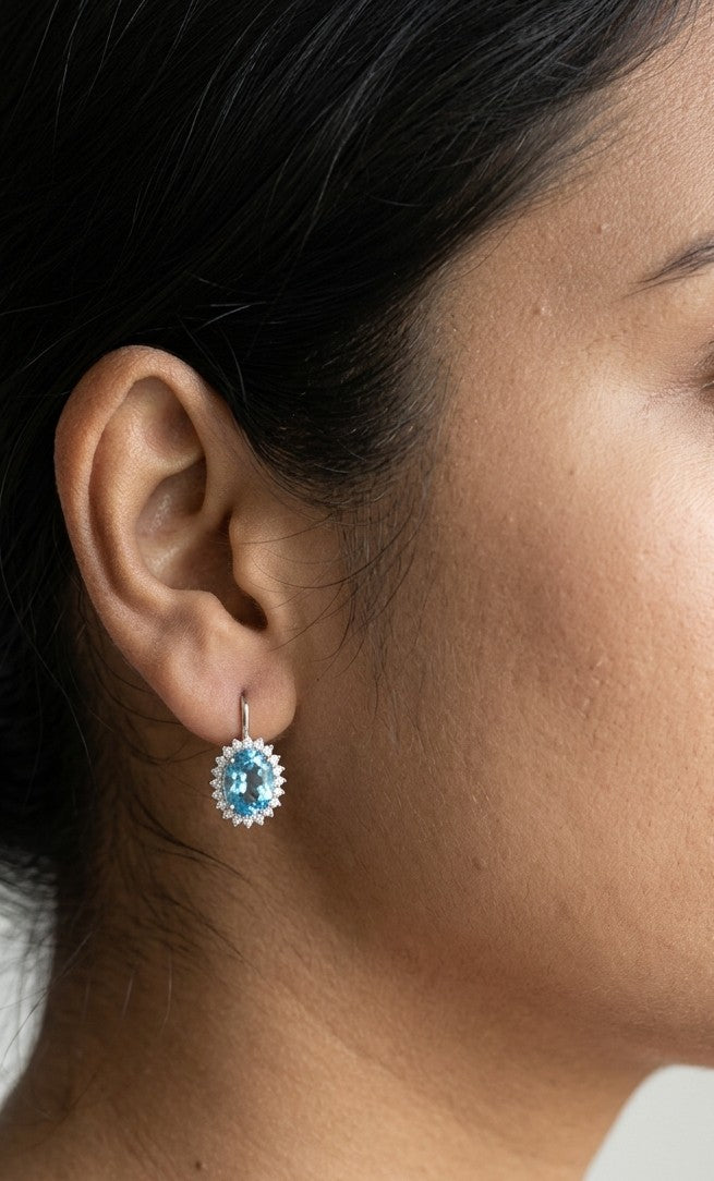 Oval Swiss Blue Topaz drop earrings with diamond halos in 18K white gold