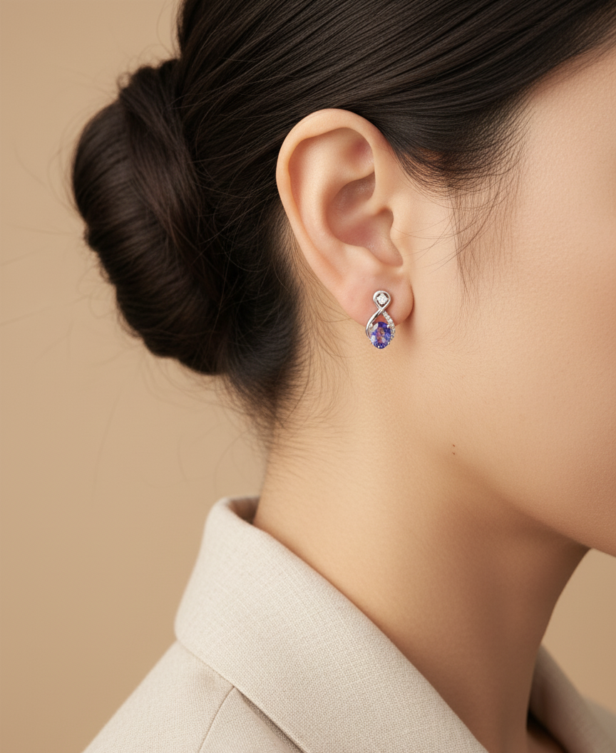 18K white gold infinity earrings with oval tanzanites and diamond accents – Emirates Diamonds.