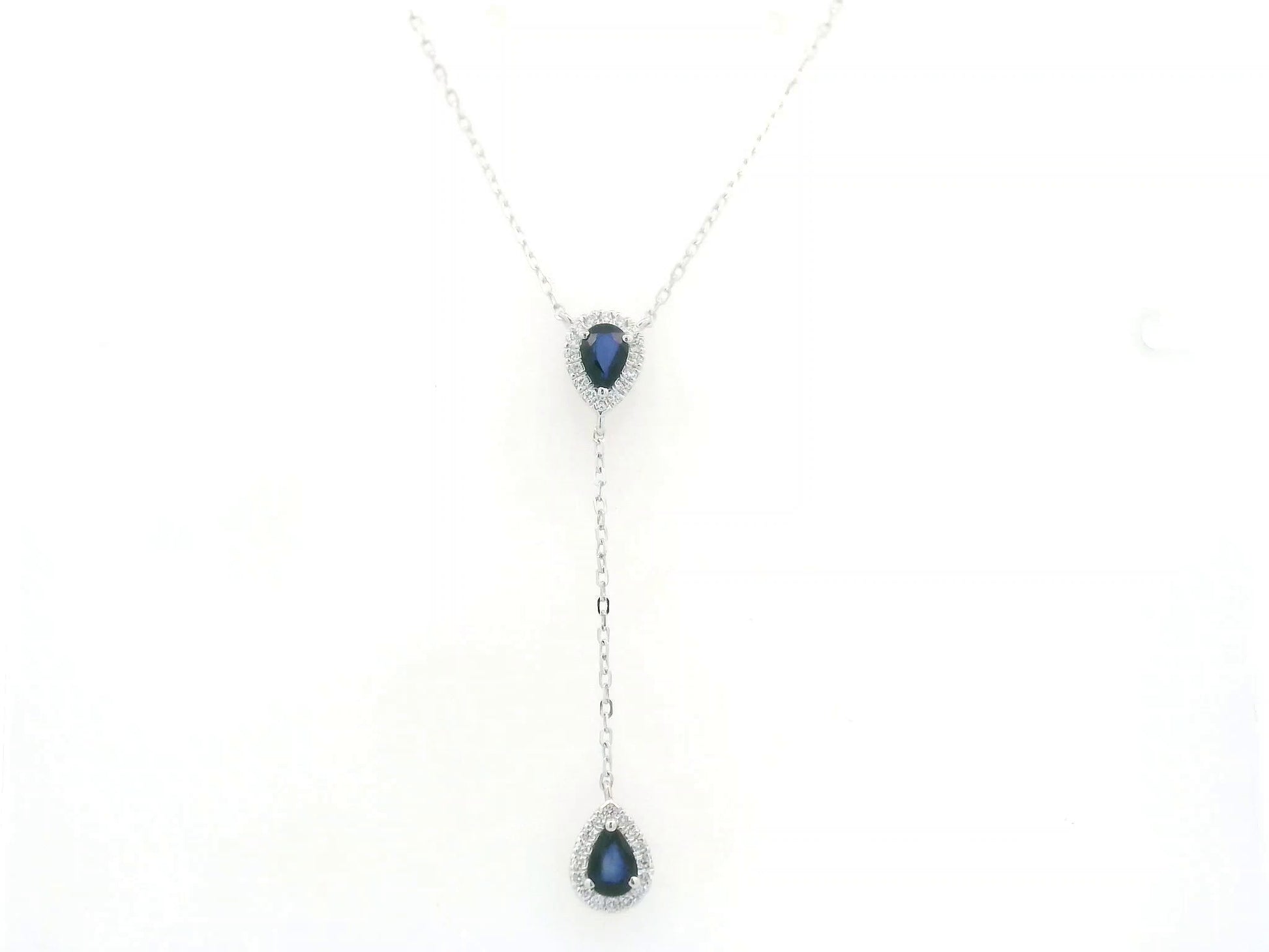 Blue sapphire and diamond drop necklace in 18K white gold featuring 1.00 carat sapphires and 0.24 carat diamonds by Emirates Diamonds.