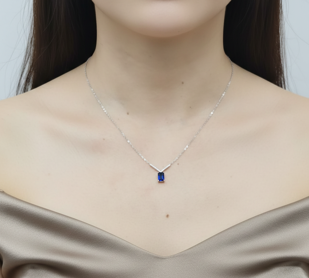 18K white gold blue sapphire and diamond V-pendant necklace by Emirates Diamonds