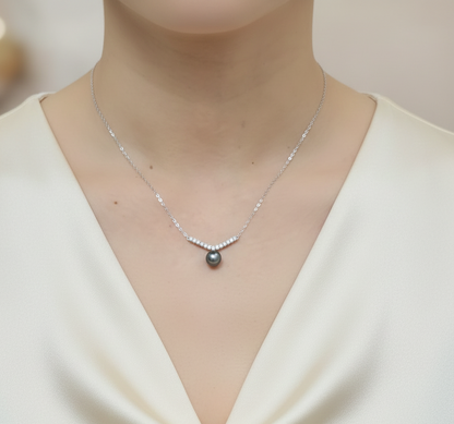 18K white gold Tahitian black pearl and diamond necklace with curved diamond accent by Emirates Diamonds