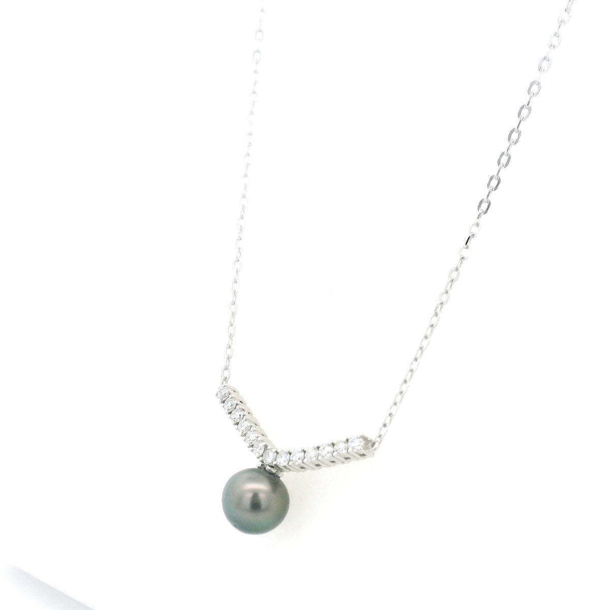 Tahitian black pearl and diamond necklace in 18K white gold featuring a dark grey pearl suspended beneath a gently curved row of round diamonds on a delicate white gold chain.