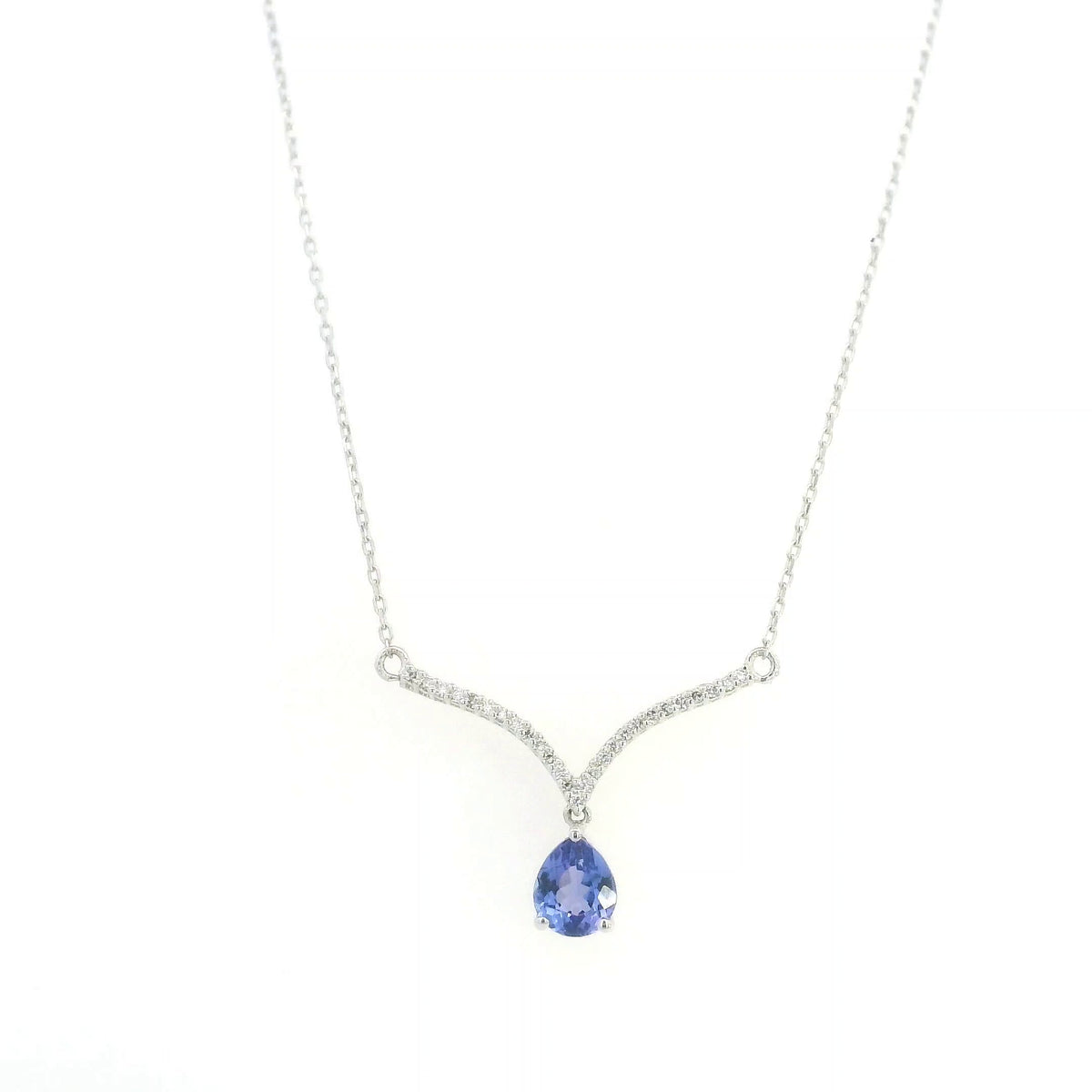 Pear shaped tanzanite and diamond necklace in 18K white gold featuring a blue-violet tanzanite drop suspended beneath two curved diamond-set bars forming a V-shaped design.