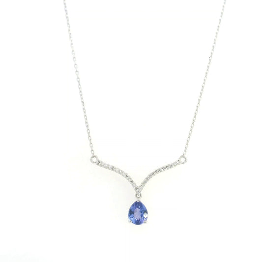 Pear shaped tanzanite and diamond necklace in 18K white gold featuring a blue-violet tanzanite drop suspended beneath two curved diamond-set bars forming a V-shaped design.
