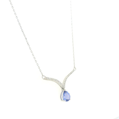 Pear shaped tanzanite and diamond necklace in 18K white gold featuring a blue-violet tanzanite drop suspended beneath two curved diamond-set bars forming a V-shaped design.