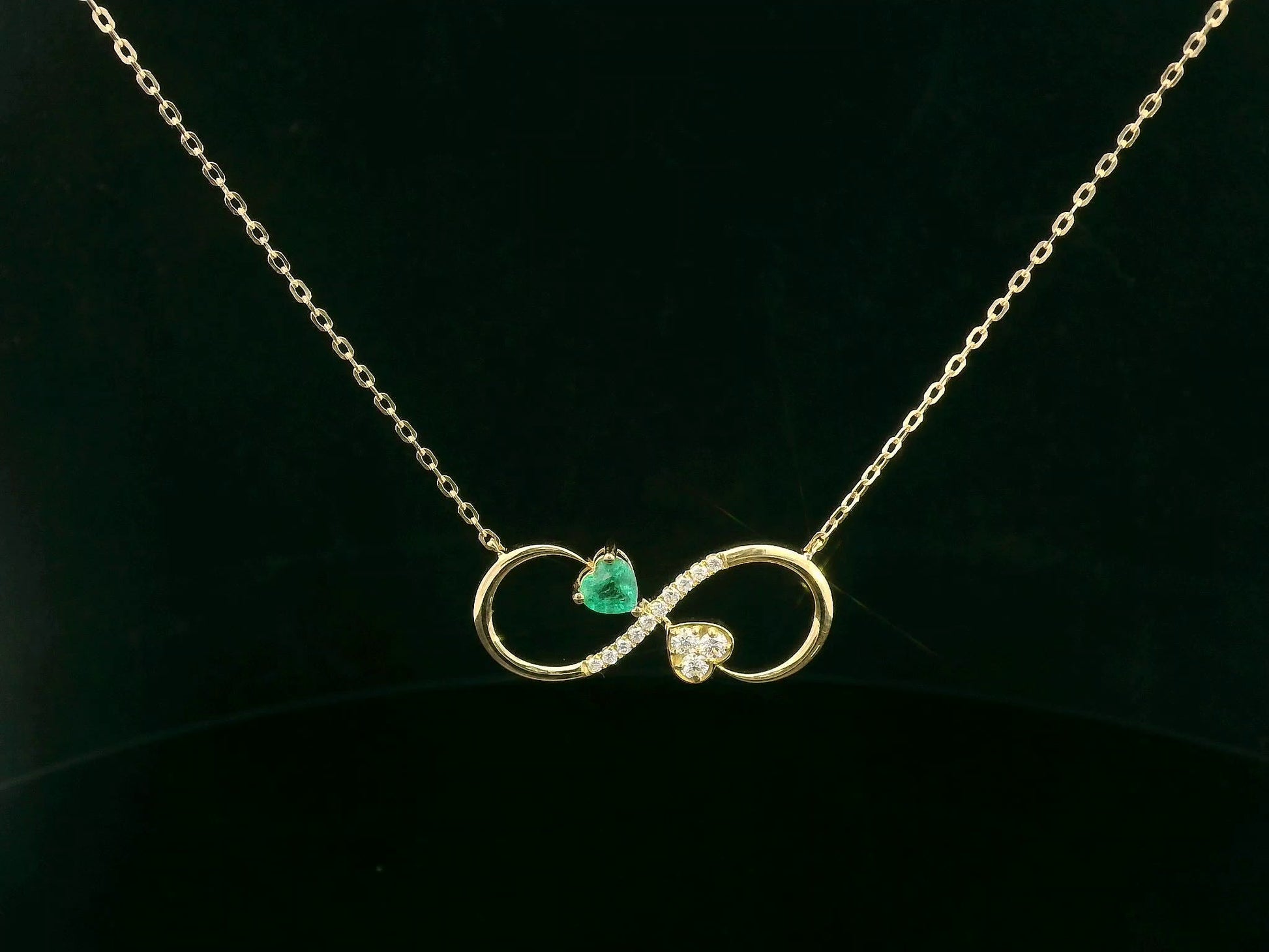 18K gold infinity necklace with emerald and diamond heart