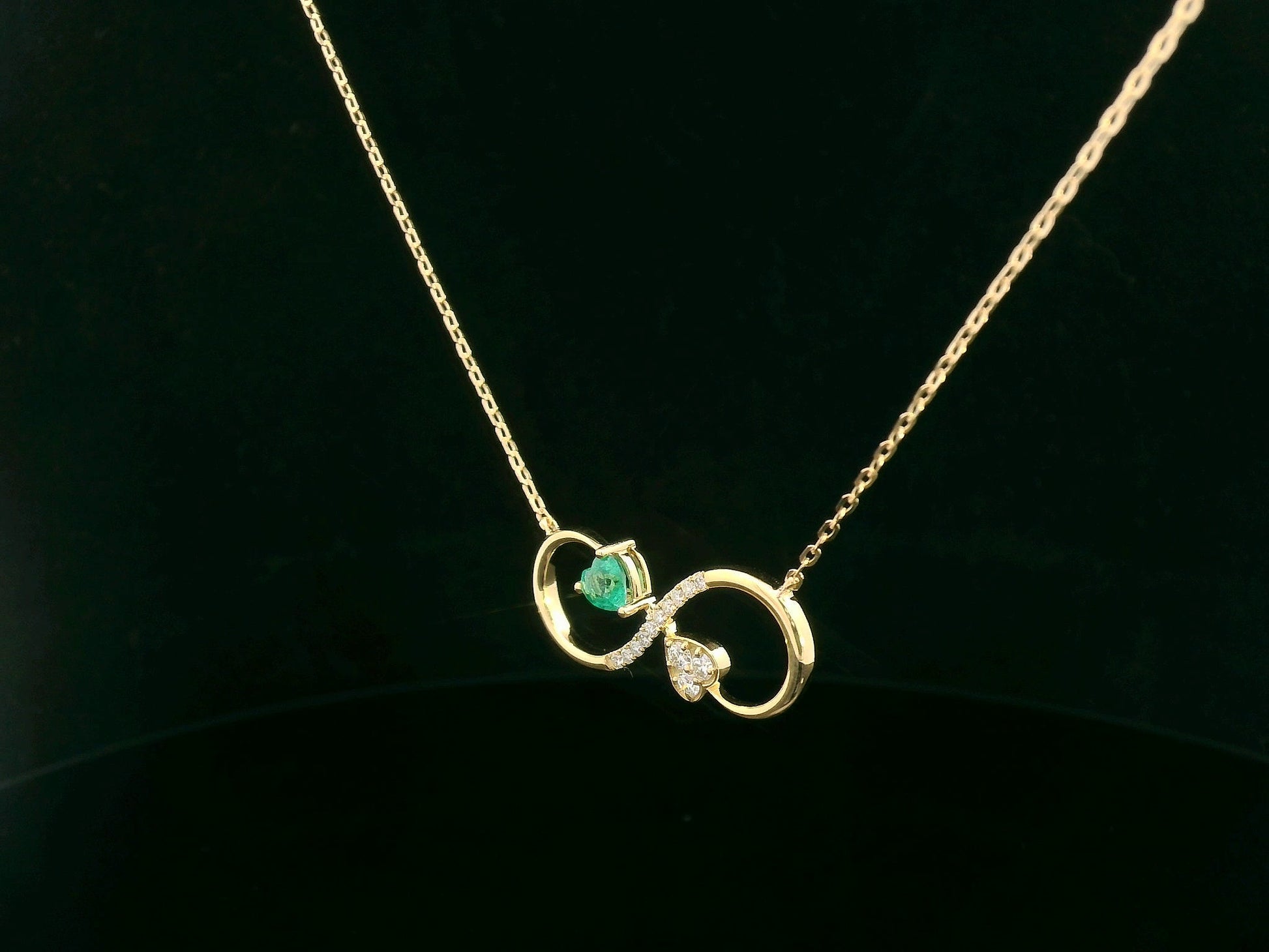 Infinity loop necklace with asymmetrical heart design