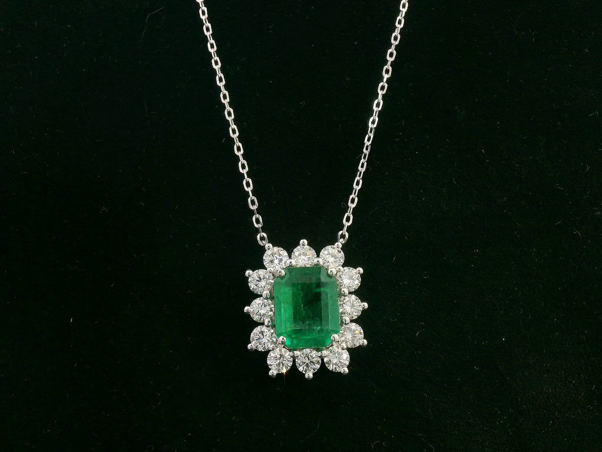 Emerald and diamond halo necklace in 18K white gold – 3.09ct emerald with 1.41ct diamond halo, fine jewelry by Emirates Diamonds