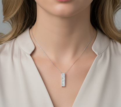 18K white gold diamond bar pendant with round and baguette-cut diamonds — 0.86ct Emirates Diamonds.