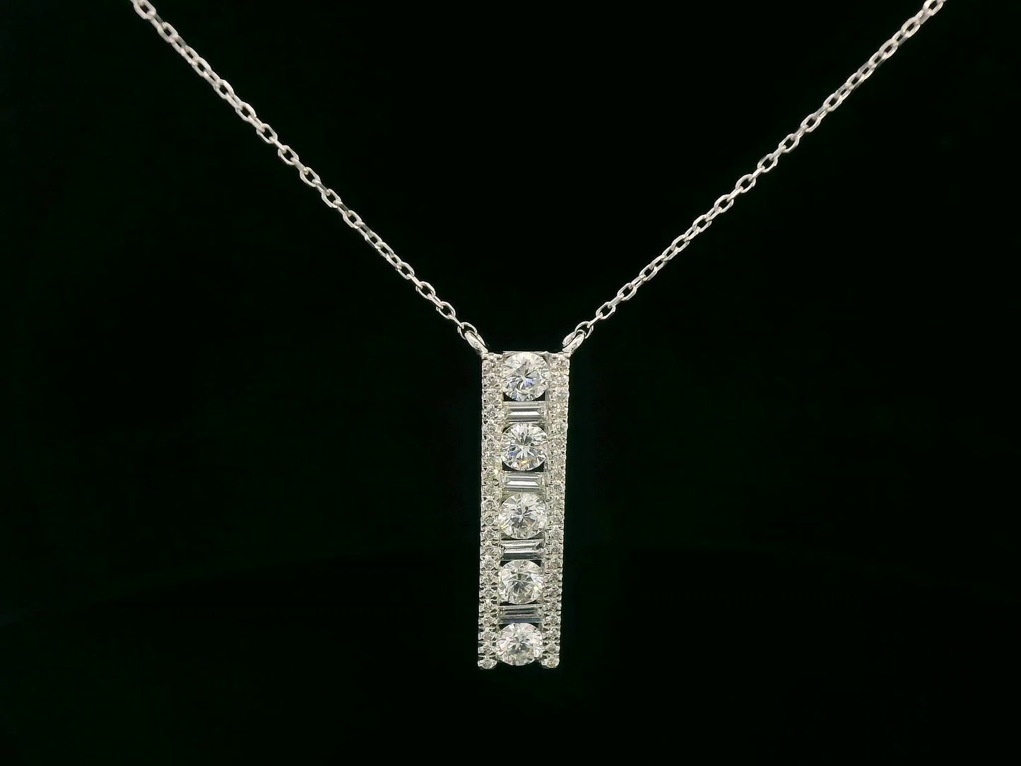 18K white gold diamond bar pendant with round and baguette-cut diamonds — 0.86ct Emirates Diamonds.