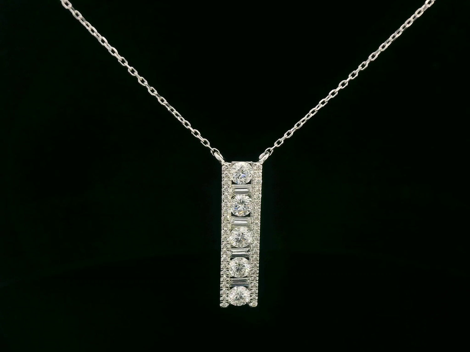 18K white gold diamond bar pendant with round and baguette-cut diamonds — 0.86ct Emirates Diamonds.