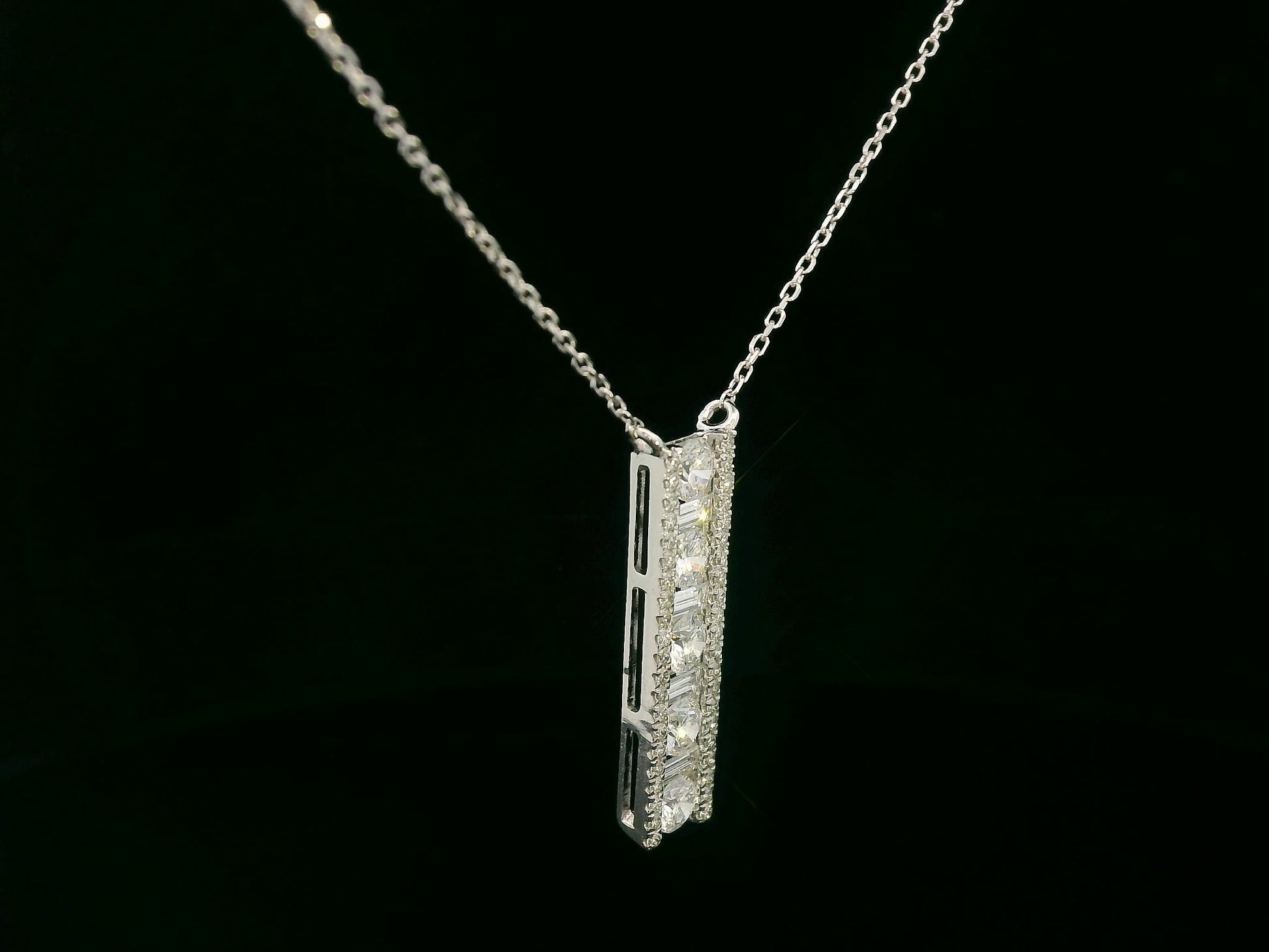 18K white gold diamond bar pendant with round and baguette-cut diamonds — 0.86ct Emirates Diamonds.
