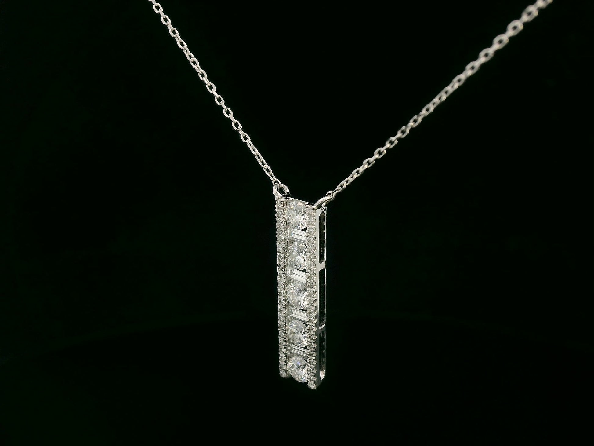 18K white gold diamond bar pendant with round and baguette-cut diamonds — 0.86ct Emirates Diamonds.