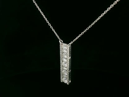18K white gold diamond bar pendant with round and baguette-cut diamonds — 0.86ct Emirates Diamonds.