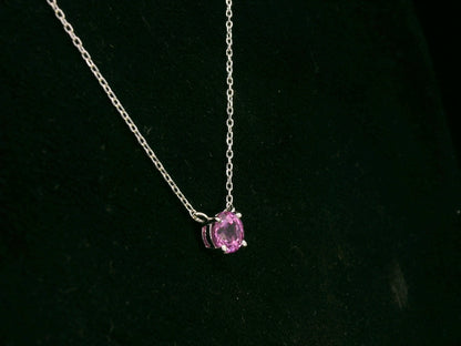 18K white gold pink sapphire solitaire necklace featuring a 0.61 carat round pink sapphire pendant by Emirates Diamonds