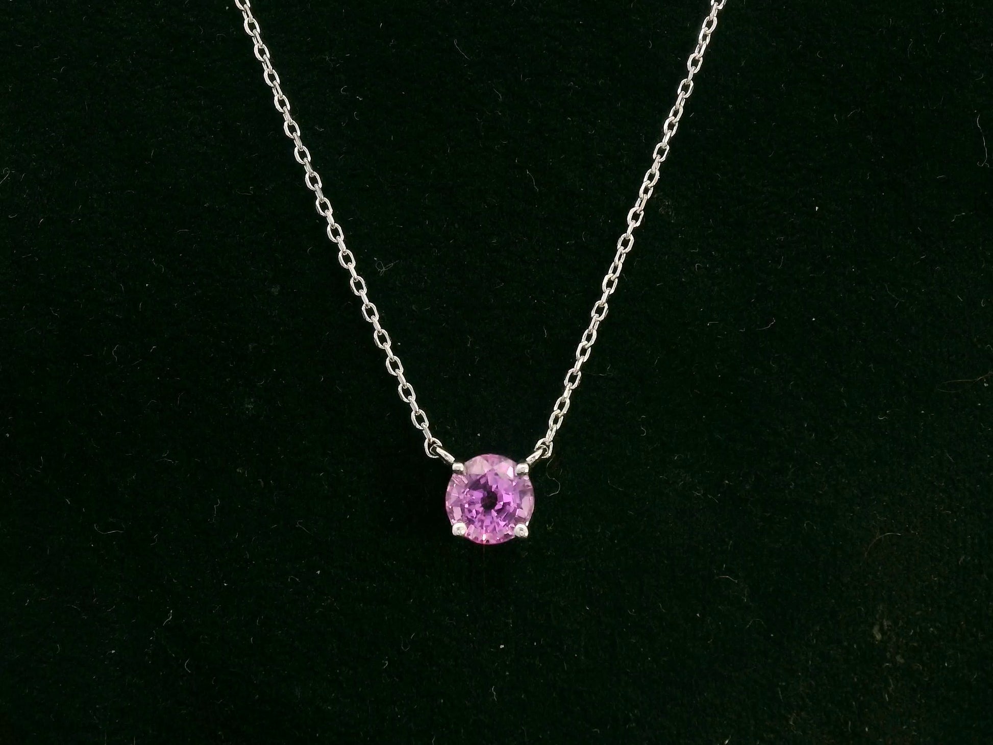 18K white gold pink sapphire solitaire necklace featuring a 0.61 carat round pink sapphire pendant by Emirates Diamonds