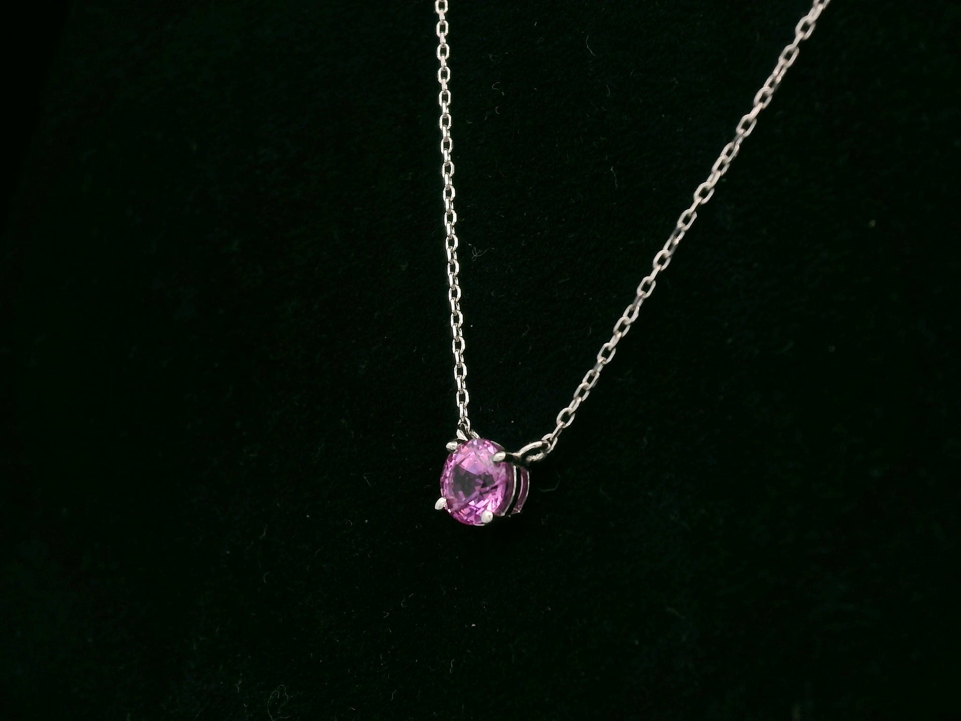 18K white gold pink sapphire solitaire necklace featuring a 0.61 carat round pink sapphire pendant by Emirates Diamonds