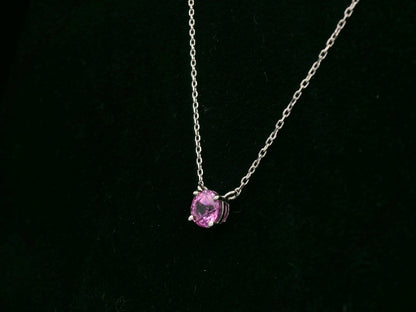 18K white gold pink sapphire solitaire necklace featuring a 0.61 carat round pink sapphire pendant by Emirates Diamonds