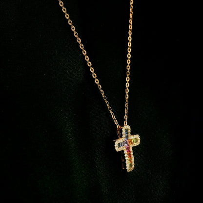 Multicolour sapphire and diamond cross necklace in 18K rose gold with colourful sapphires surrounded by round brilliant diamonds.
