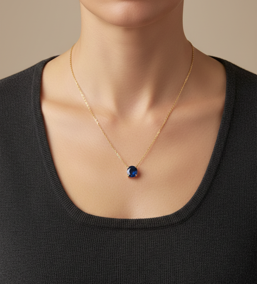 Round blue sapphire solitaire necklace in 18K yellow gold by Emirates Diamonds