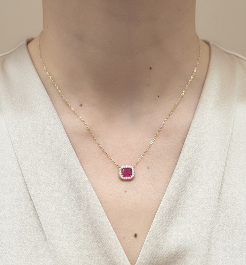 18K yellow gold ruby necklace with cushion-cut ruby and diamond halo by Emirates Diamonds