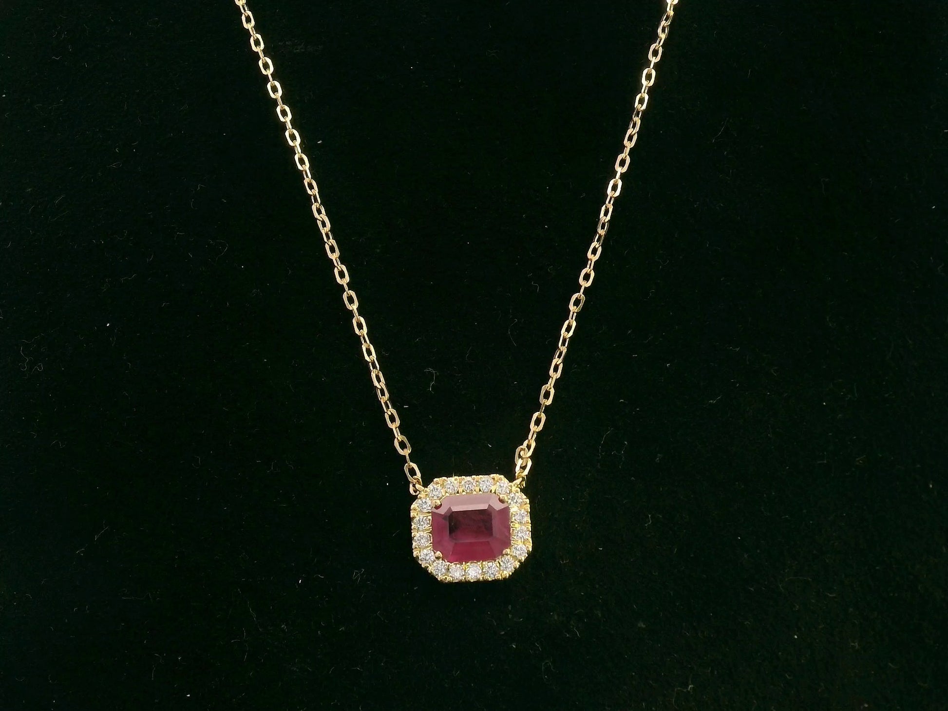 18K yellow gold ruby necklace with cushion-cut ruby and diamond halo by Emirates Diamonds