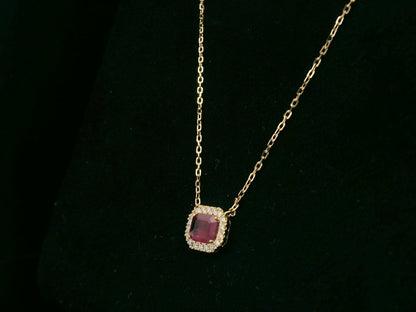 18K yellow gold ruby necklace with cushion-cut ruby and diamond halo by Emirates Diamonds