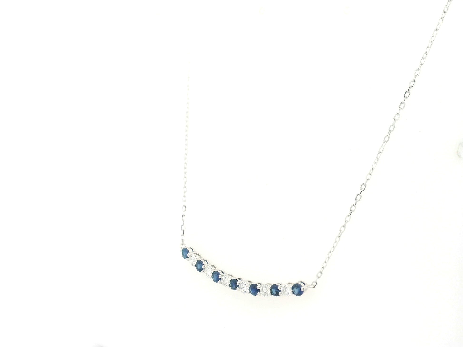 Blue sapphire and diamond bar necklace in 18K white gold featuring 0.74 carats of sapphires and 0.55 carats of diamonds by Emirates Diamonds.