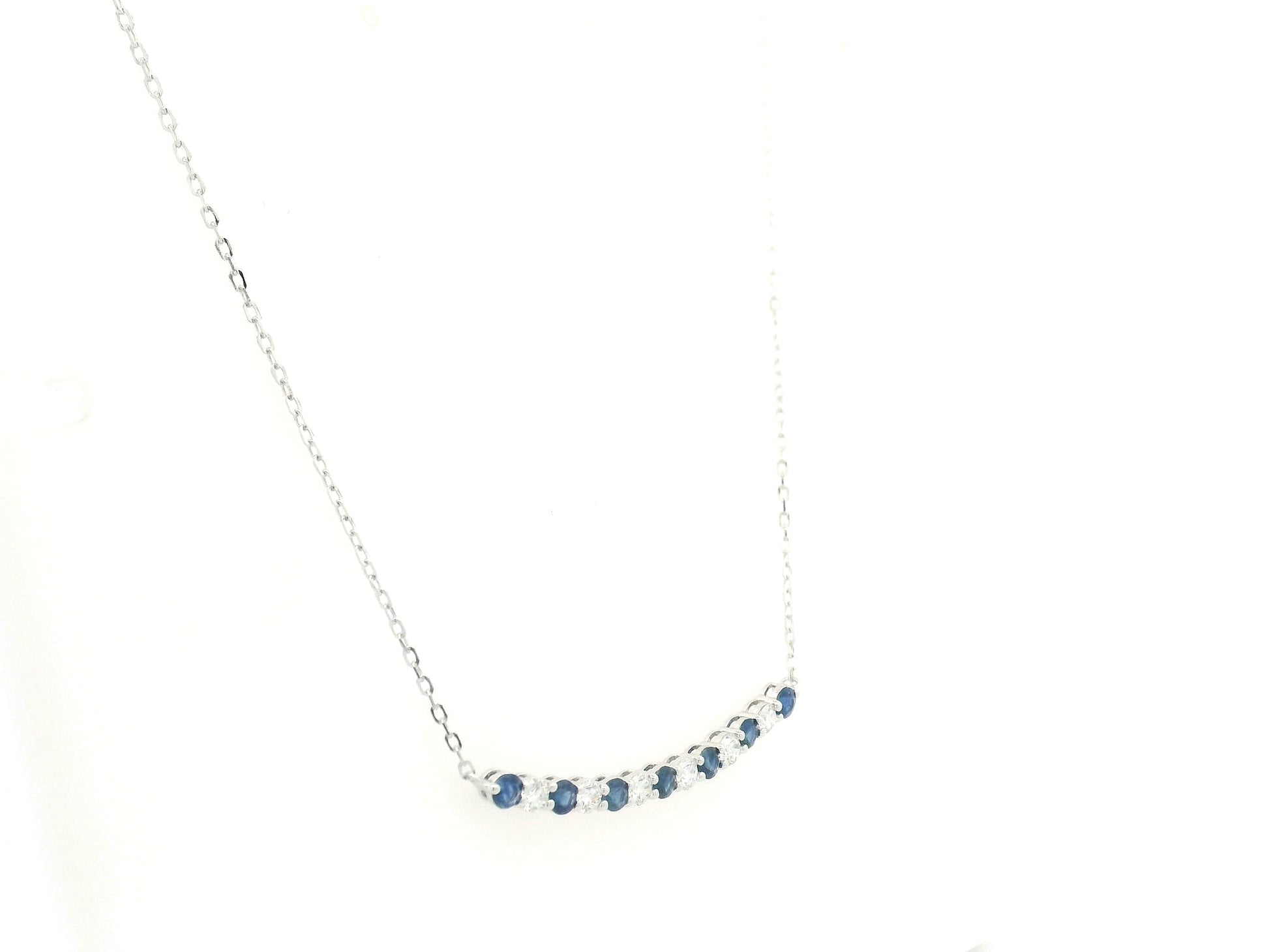 Blue sapphire and diamond bar necklace in 18K white gold featuring 0.74 carats of sapphires and 0.55 carats of diamonds by Emirates Diamonds.