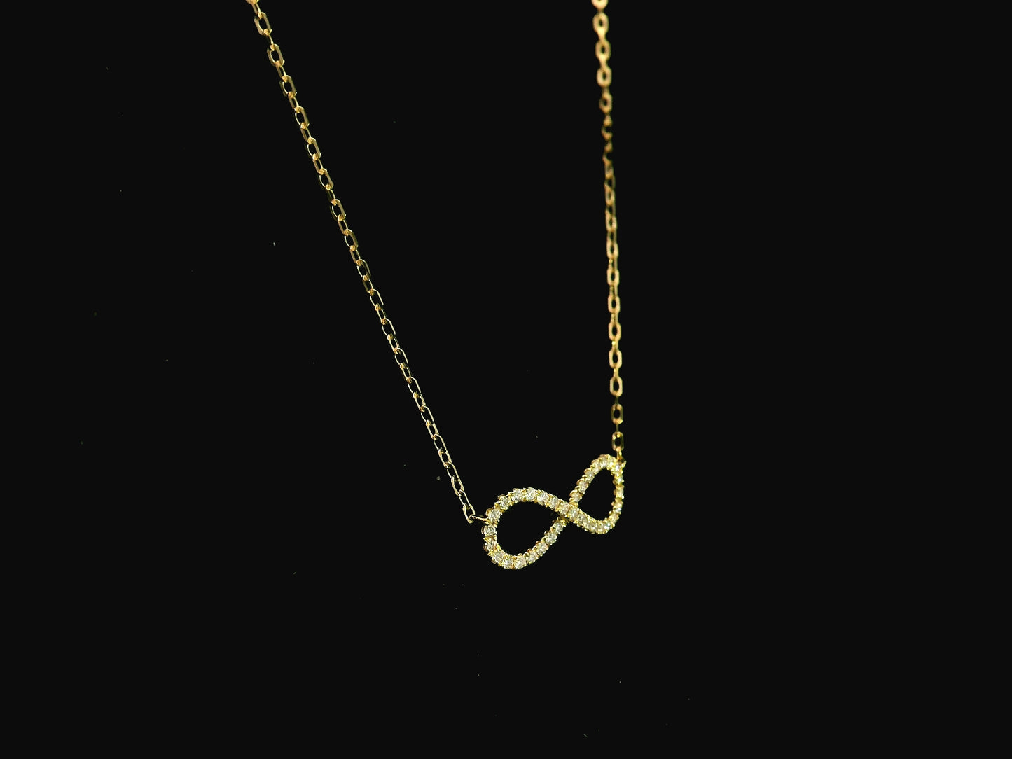Diamond infinity necklace in 18K yellow gold featuring 0.19 carats of diamonds by Emirates Diamonds.