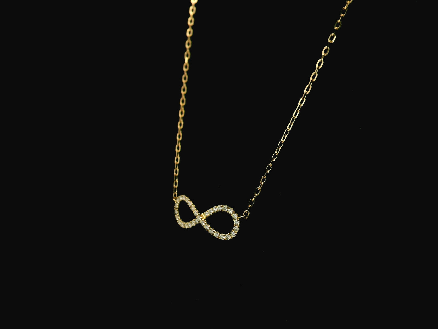 Diamond infinity necklace in 18K yellow gold featuring 0.19 carats of diamonds by Emirates Diamonds.
