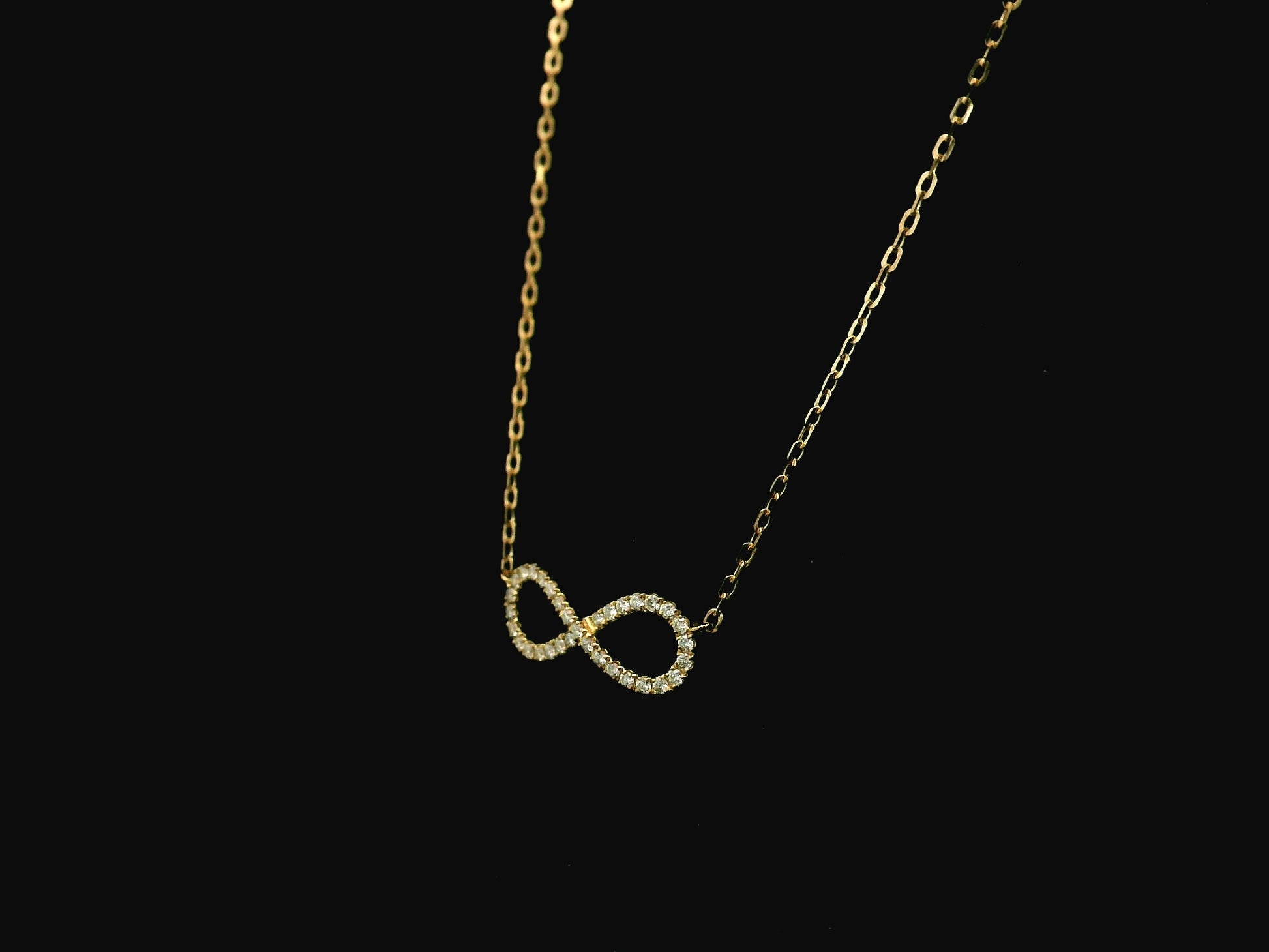 Diamond infinity necklace in 18K yellow gold featuring 0.19 carats of diamonds by Emirates Diamonds.