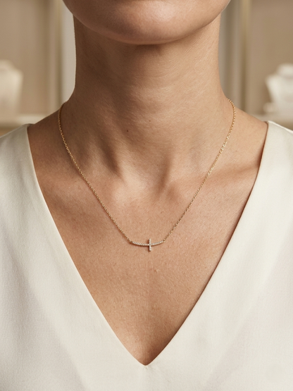 Diamond cross necklace in 18K yellow gold featuring 0.06 carats of diamonds by Emirates Diamonds.