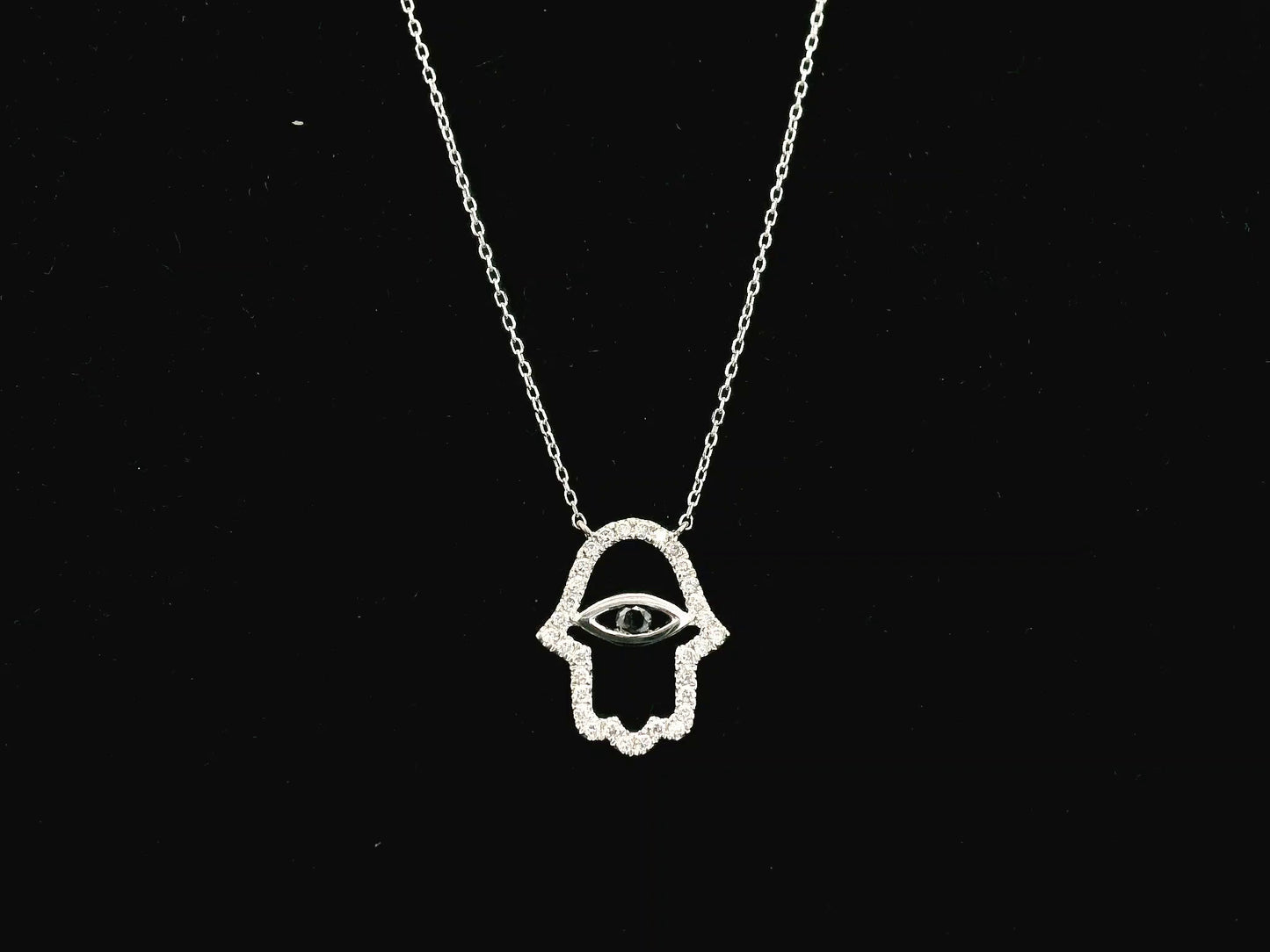 Diamond Hamsa evil eye pendant necklace in 18K white gold with black diamond center by Emirates Diamonds