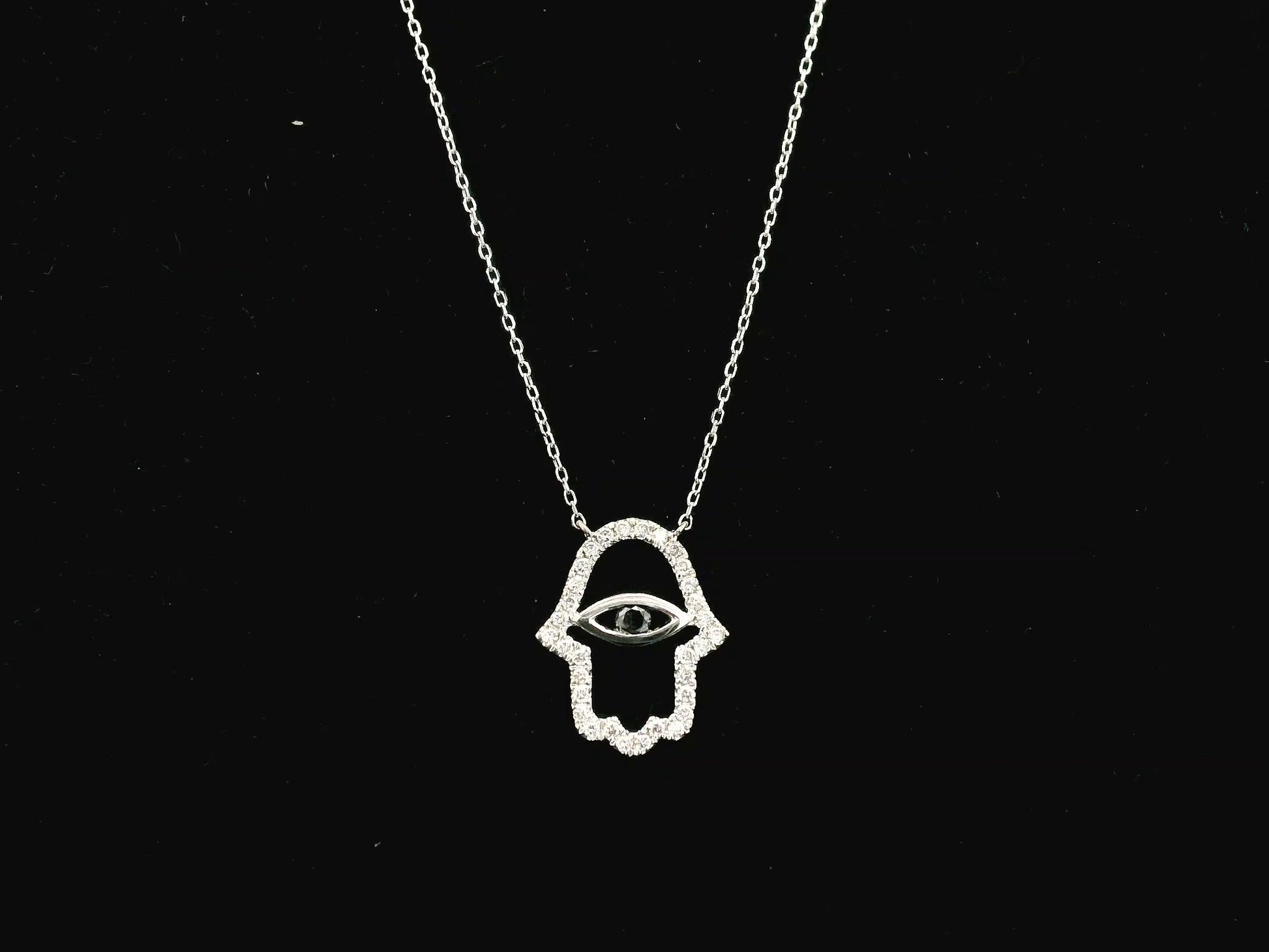 Diamond Hamsa evil eye pendant necklace in 18K white gold with black diamond center by Emirates Diamonds