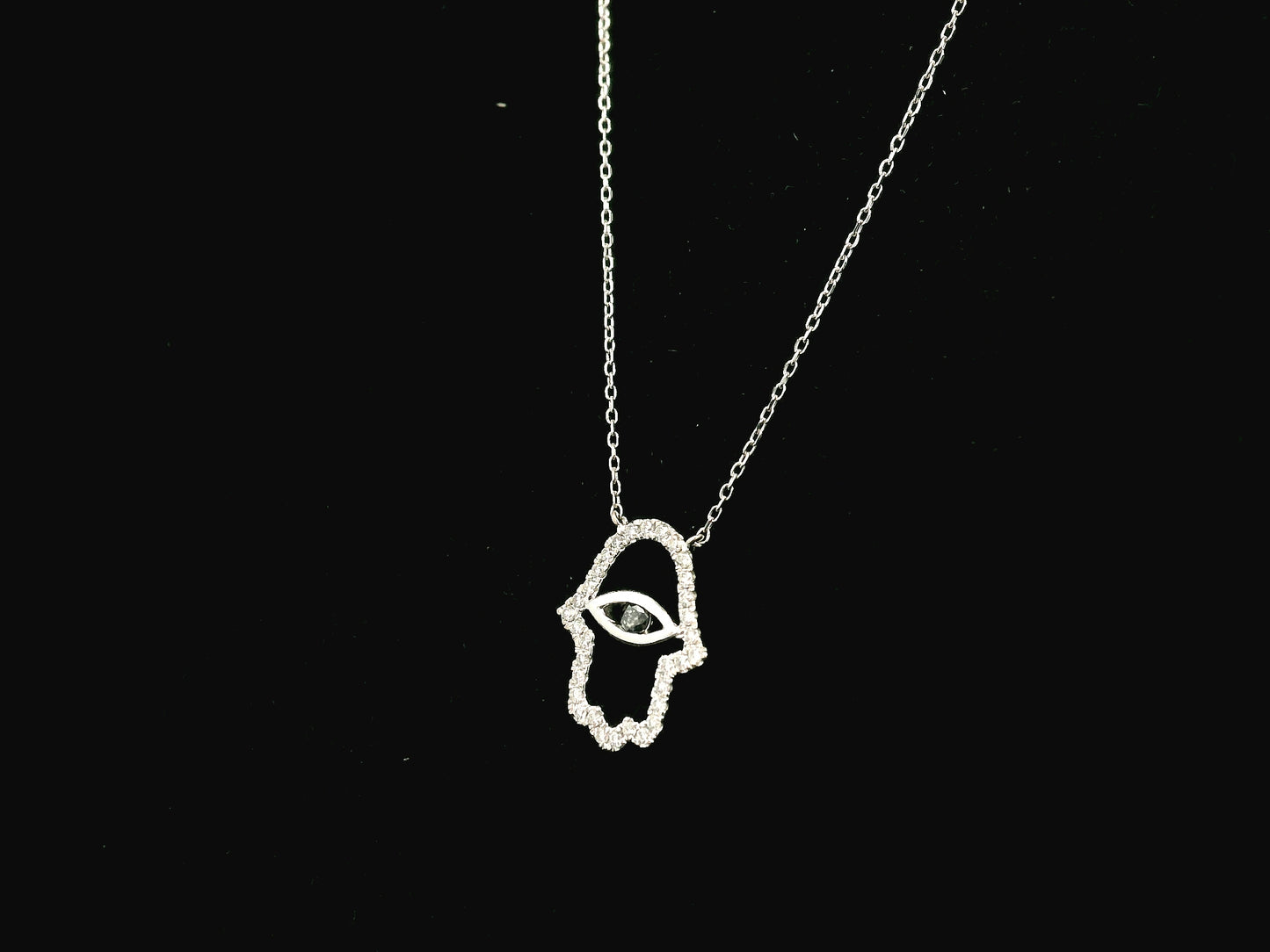 Diamond Hamsa evil eye pendant necklace in 18K white gold with black diamond center by Emirates Diamonds