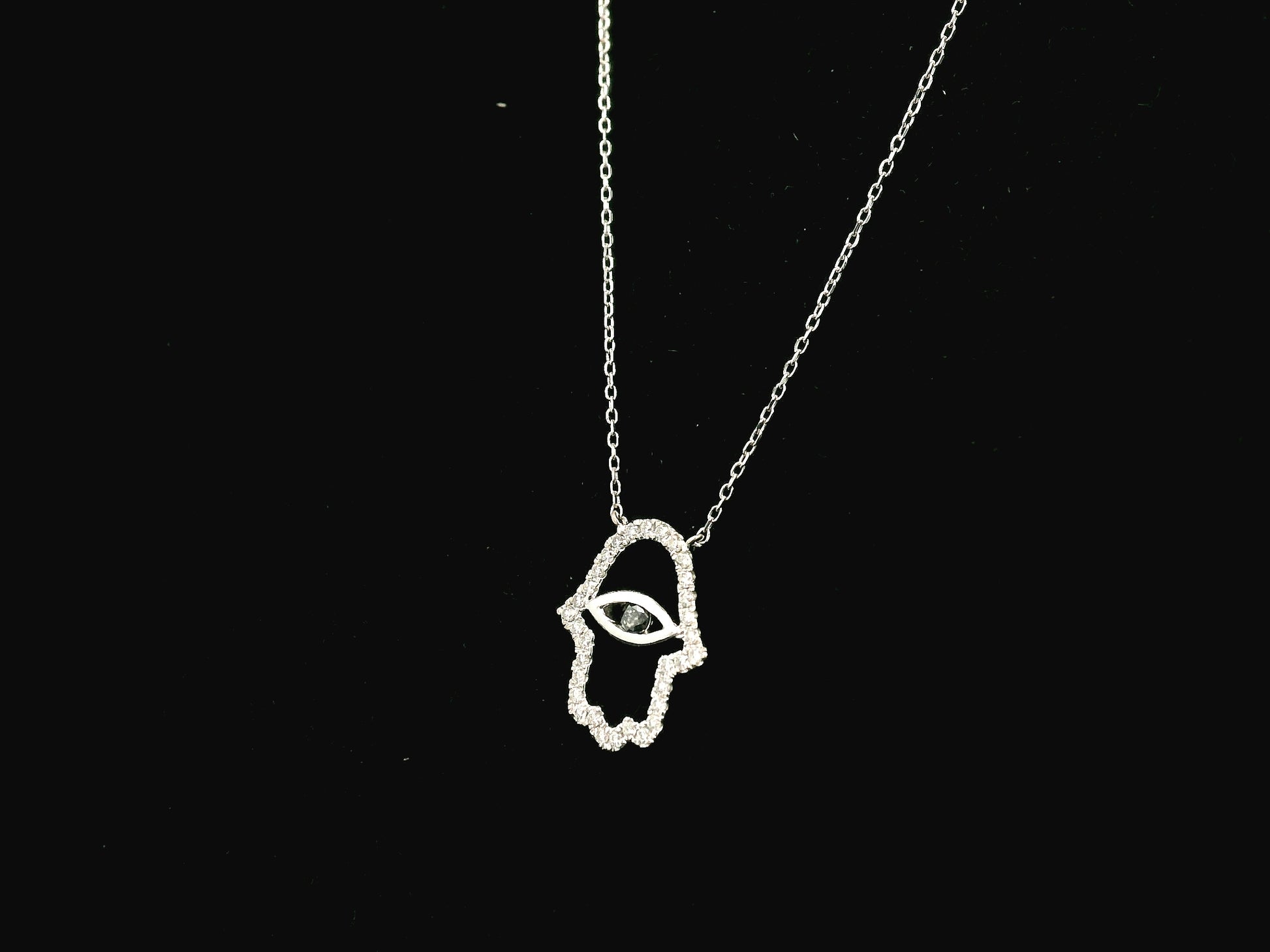 Diamond Hamsa evil eye pendant necklace in 18K white gold with black diamond center by Emirates Diamonds