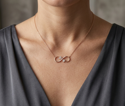 18K rose gold infinity heart necklace with pavé diamonds and double heart design.