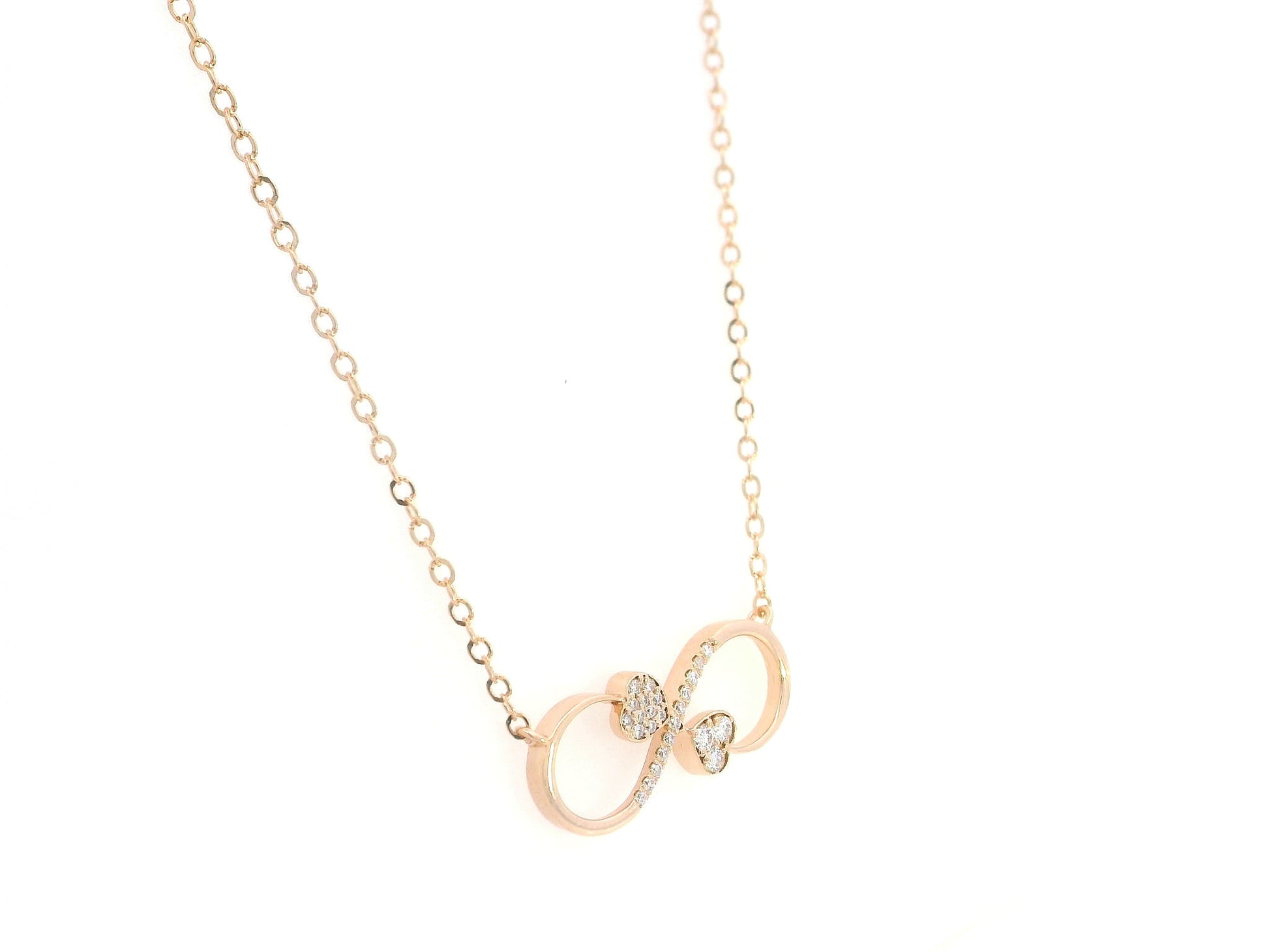 18K rose gold infinity heart necklace with pavé diamonds and double heart design.