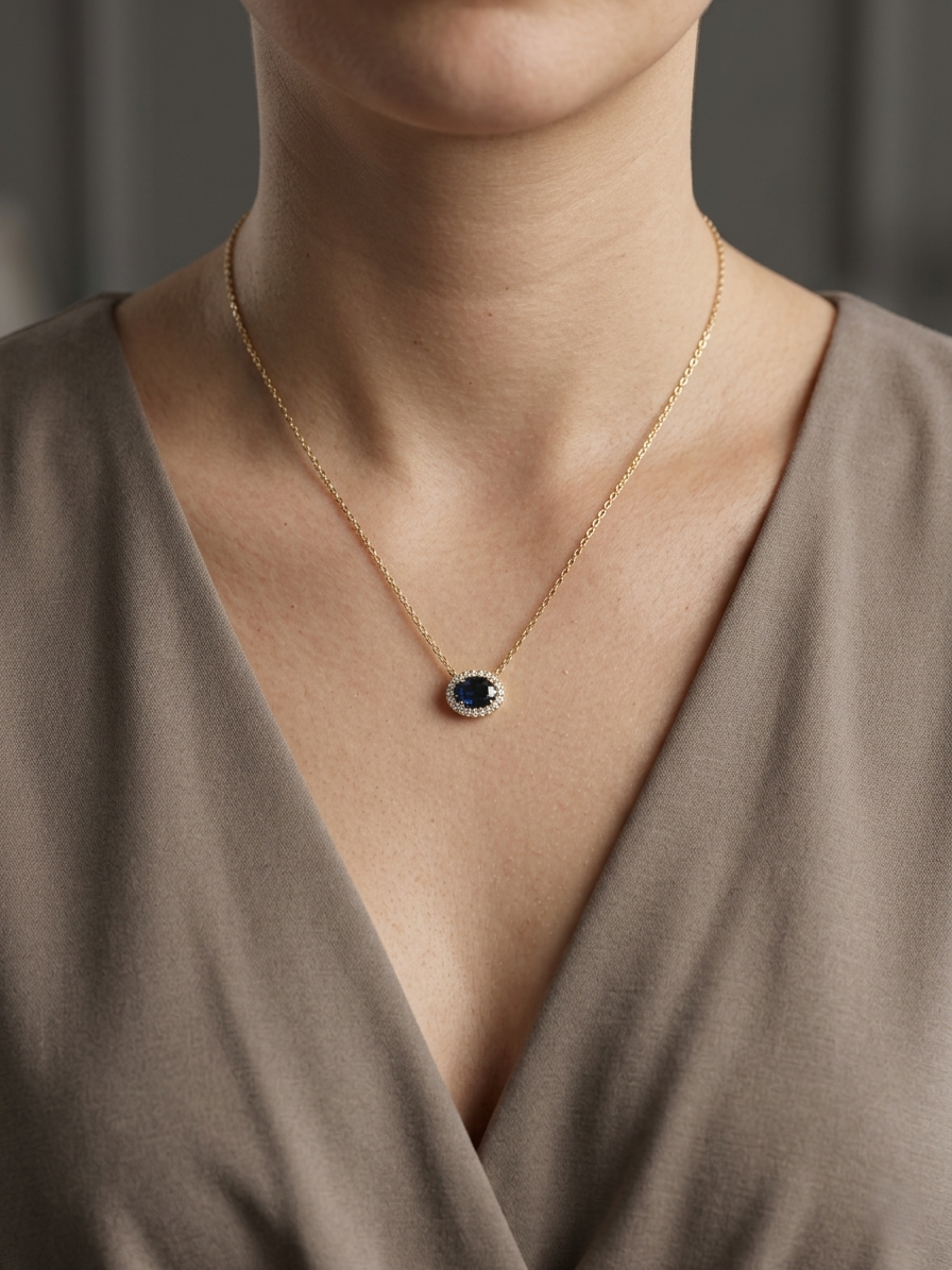18K yellow gold sapphire and diamond halo pendant necklace with oval blue sapphire center stone
