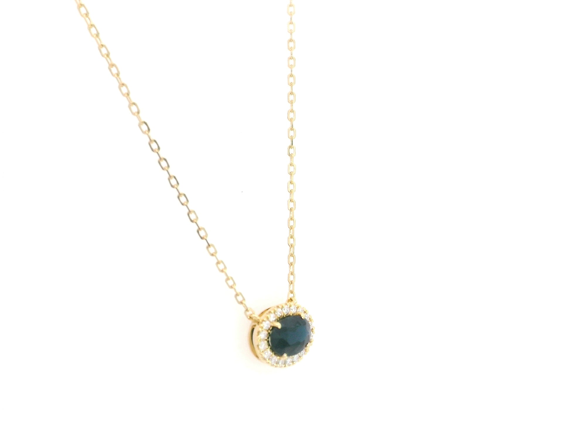18K yellow gold sapphire and diamond halo pendant necklace with oval blue sapphire center stone