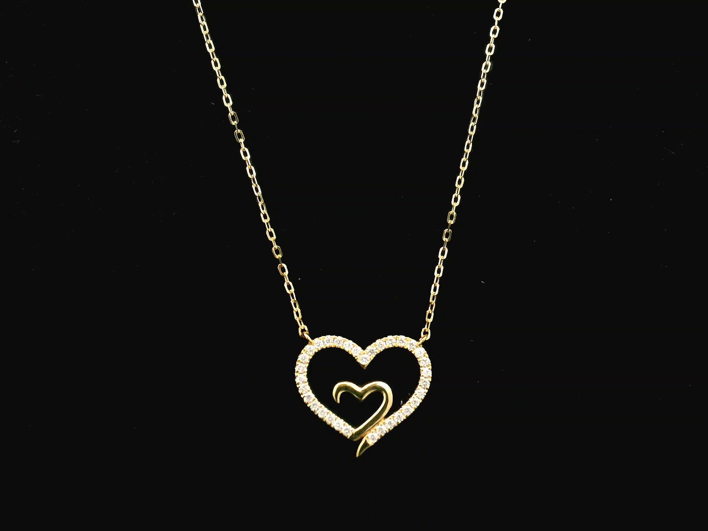 18K yellow gold open heart diamond necklace with pavé diamonds and modern romantic design.