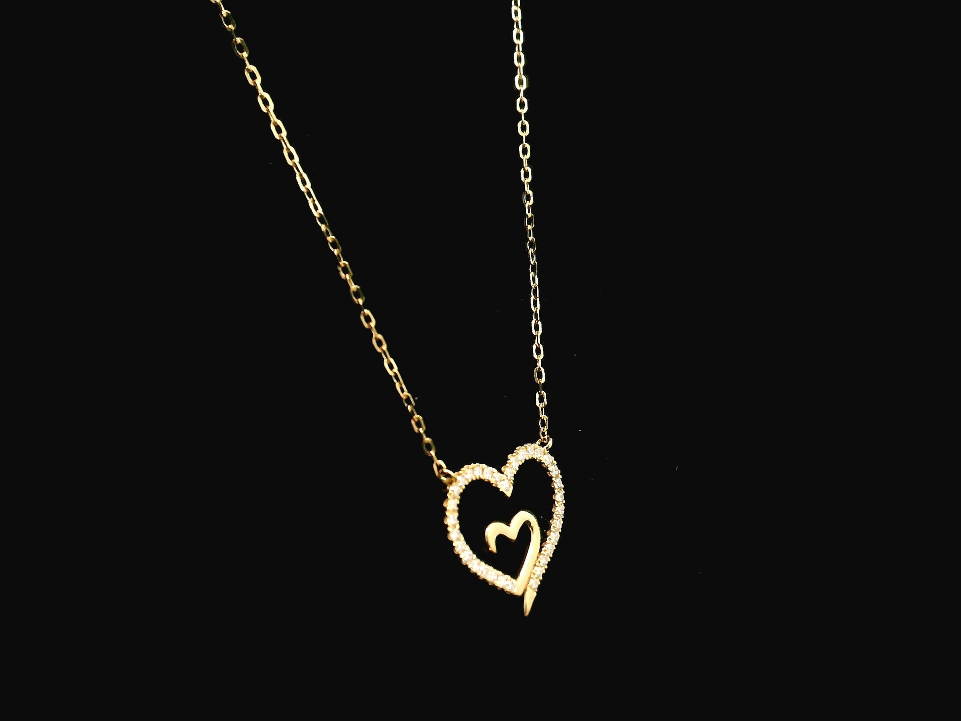 18K yellow gold open heart diamond necklace with pavé diamonds and modern romantic design.