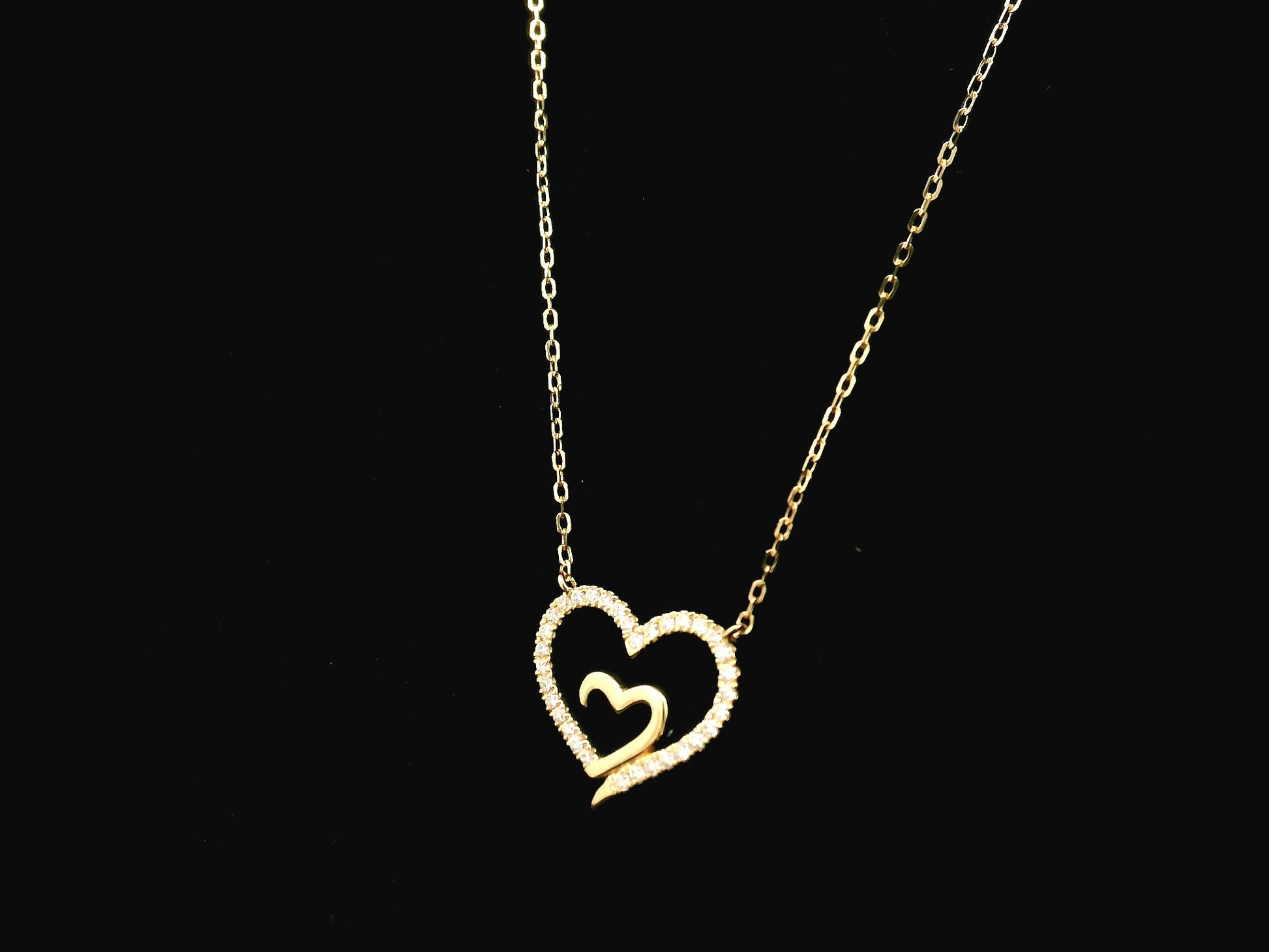 18K yellow gold open heart diamond necklace with pavé diamonds and modern romantic design.