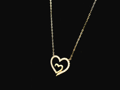 18K yellow gold open heart diamond necklace with pavé diamonds and modern romantic design.