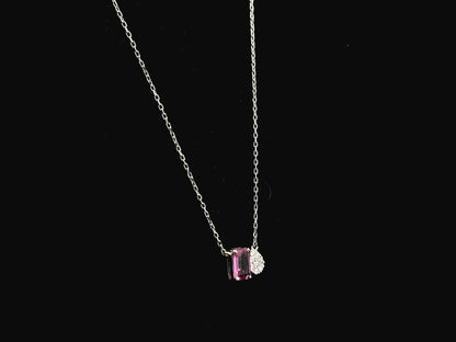 18K white gold pendant necklace featuring a 0.63 carat emerald cut pink sapphire paired with a 0.07 carat pear shaped diamond.