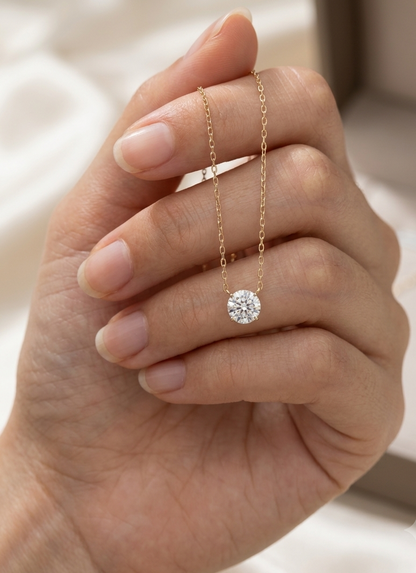 18K yellow gold solitaire necklace featuring a 1.01 carat GIA certified round brilliant natural diamond in a classic four-prong setting.