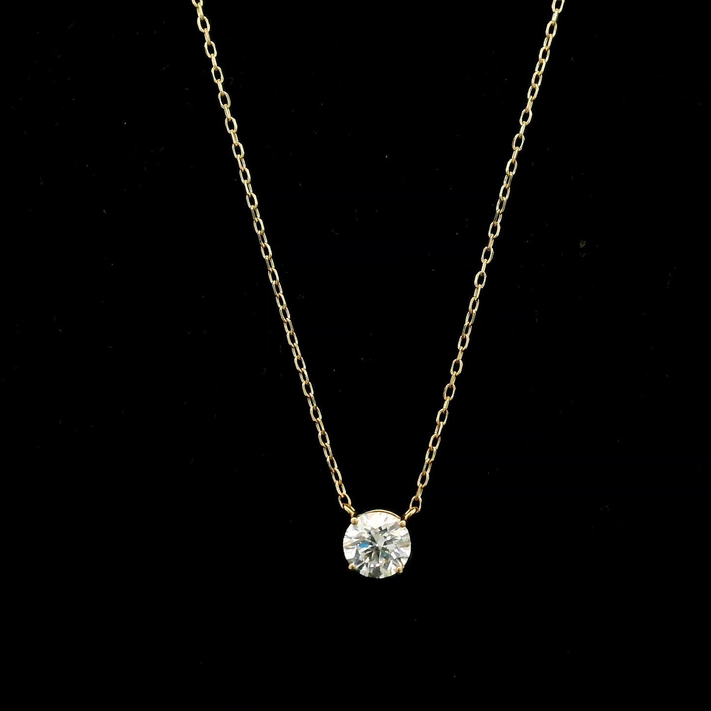 18K yellow gold solitaire necklace featuring a 1.01 carat GIA certified round brilliant natural diamond in a classic four-prong setting.